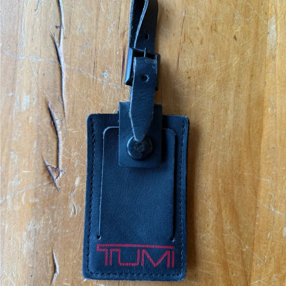 Tumi Black Leather Luggage Tag with Black Buckle And Red Lettering